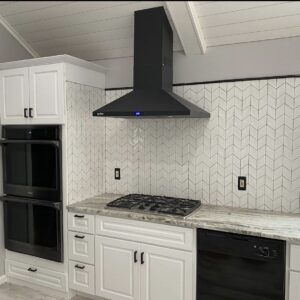 Elegant kitchen with marble countertops and detailed tile backsplash
