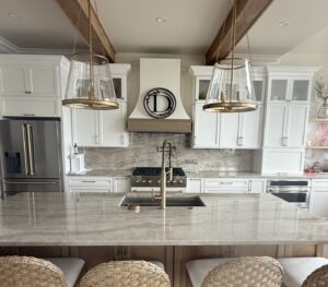 kitchen with marble countertops, backsplash, and white cabinets